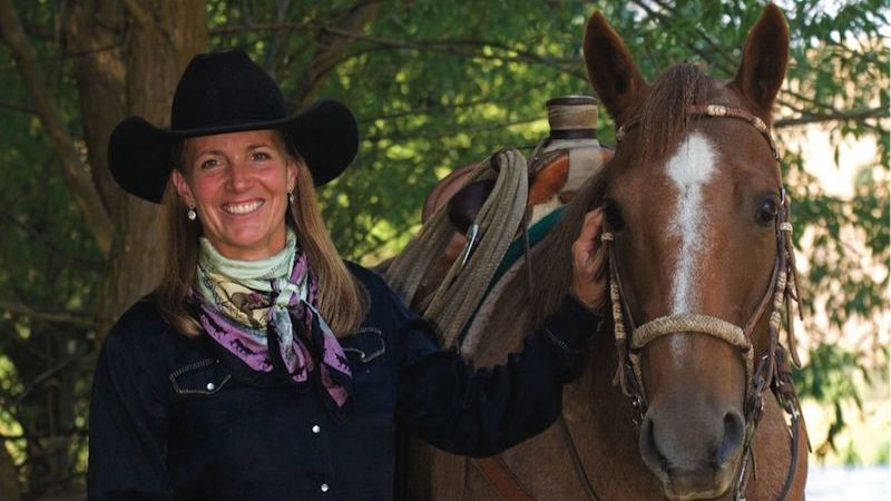 liza jane nichols standing with horse
