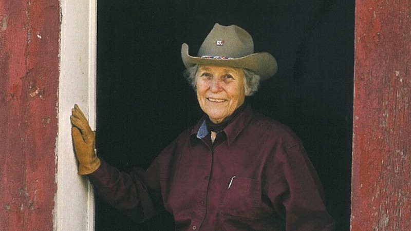 Linda Davis leaning in barn doorway
