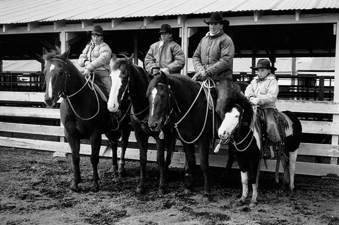 Bryan Neubert (second from right) taught his children (from left) Kate, Jim and Luke, to focus on a horse's good traits.