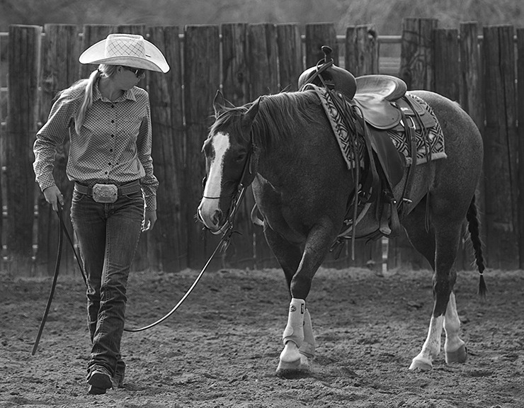 woman walking with horse