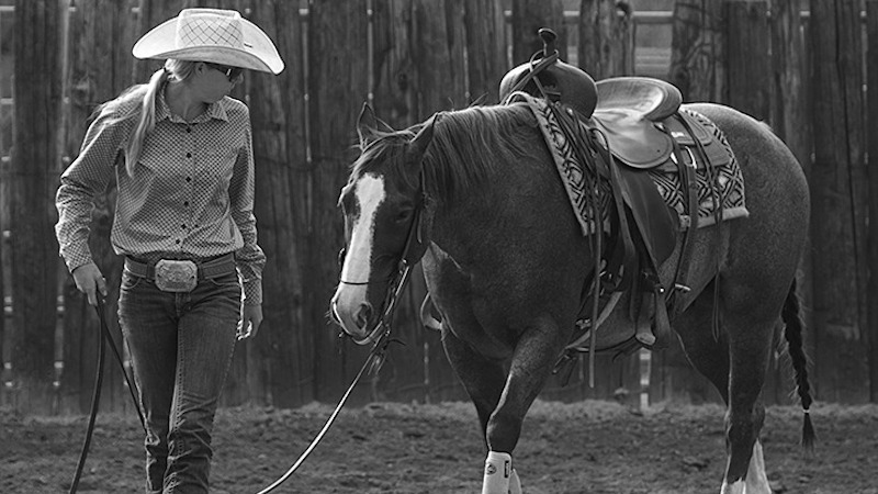 woman walking horse