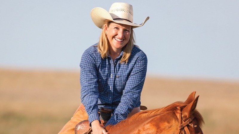 Lori White smiling on horseback