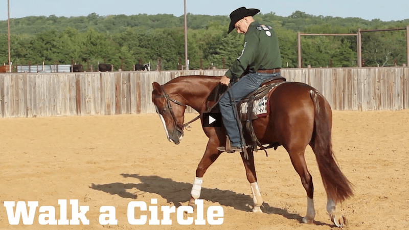 Ron Ralls riding a horse in a circle