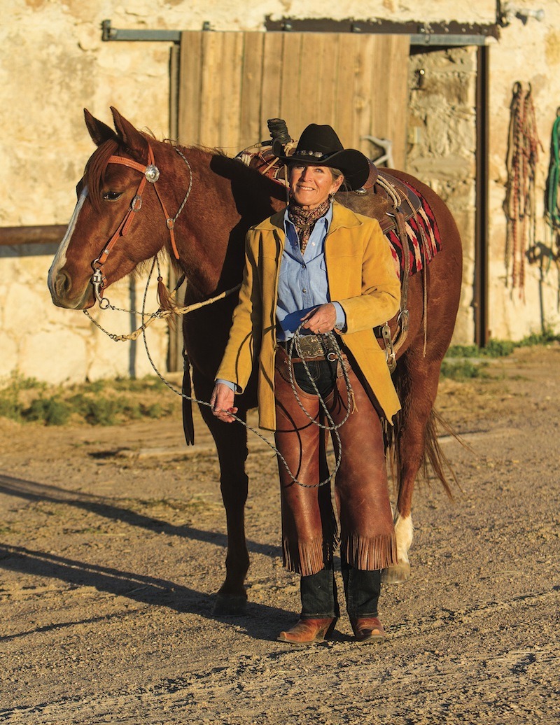 Sylvia McComber standing by horse