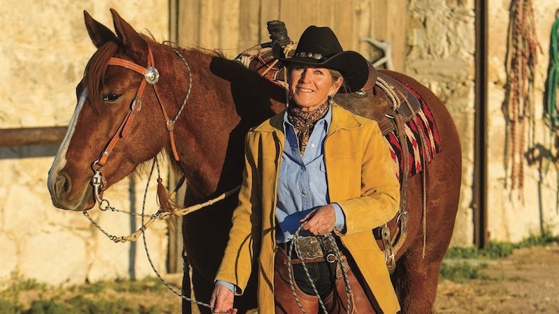 sylvia mccomber standing by horse