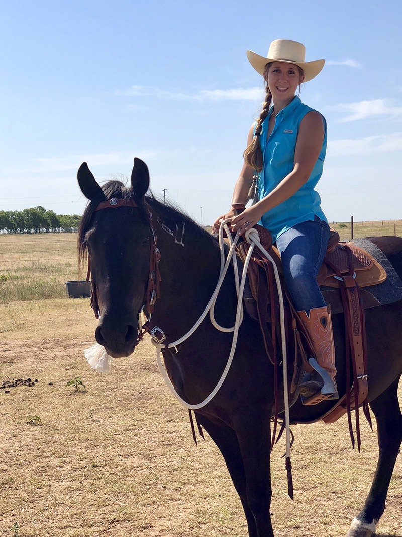 Shelby Crider saddled up on mustang Pearl