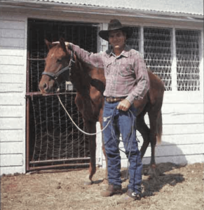 Tommy Lee Jones standing with horse