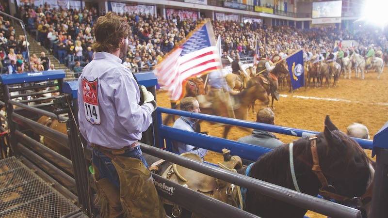 Tyler Bridges standing behind bucking chutes during national anthem