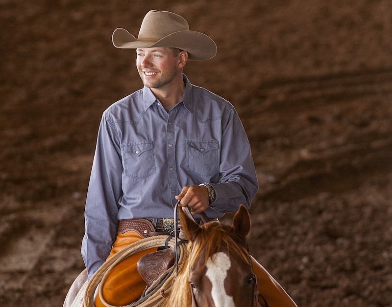 Ben Baldus smiling on horseback in arena