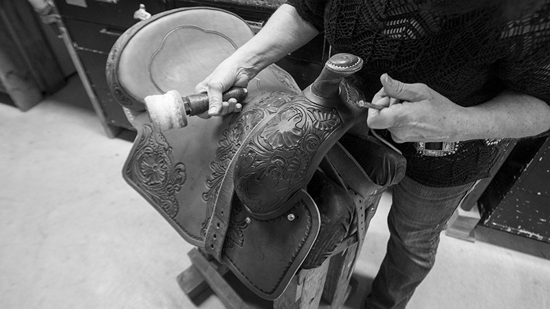 saddle maker stamping leather