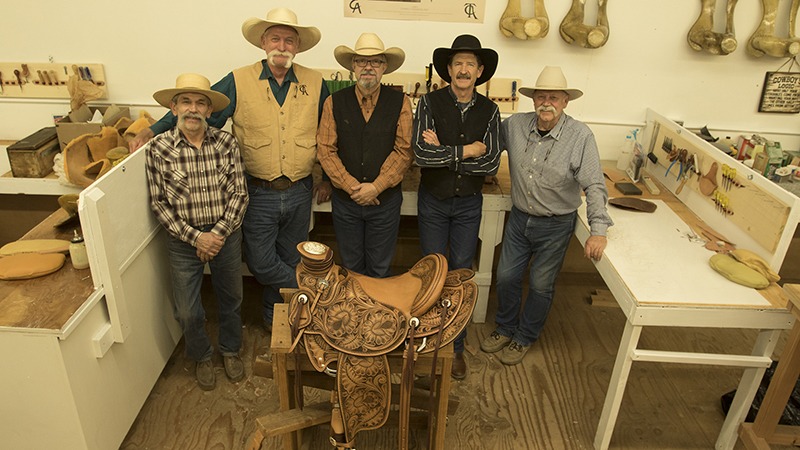 saddlemakers standing in front of Wade saddle