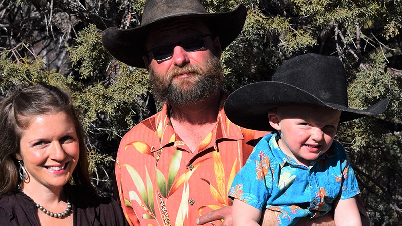 real life ranch wife jolyn young standing with husband and son
