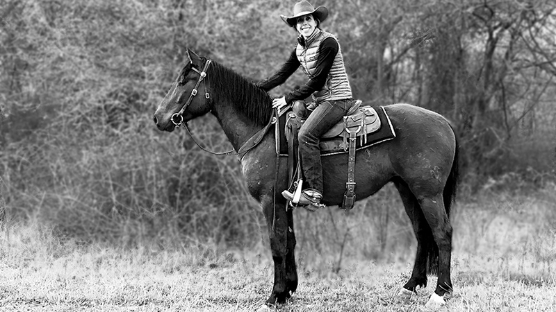 Kelli Neubert riding an Azteca horse