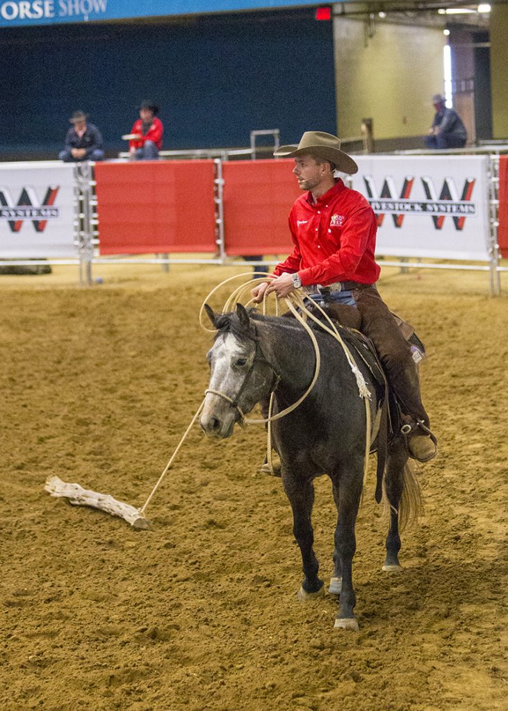 Ben Baldus drags a log with his grey colt