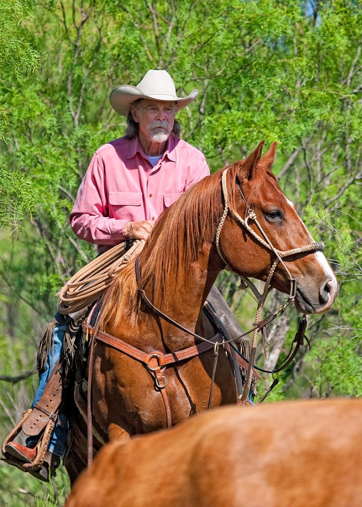 Buck Taylor horseback on sorrel horse
