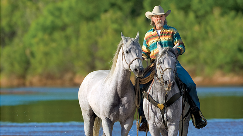 buck taylor riding horses in water