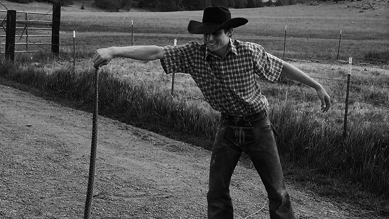 cowboy holding snake