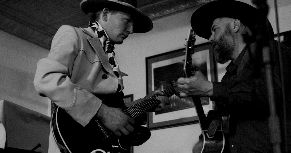 Justin Reichert and Ira G play guitar