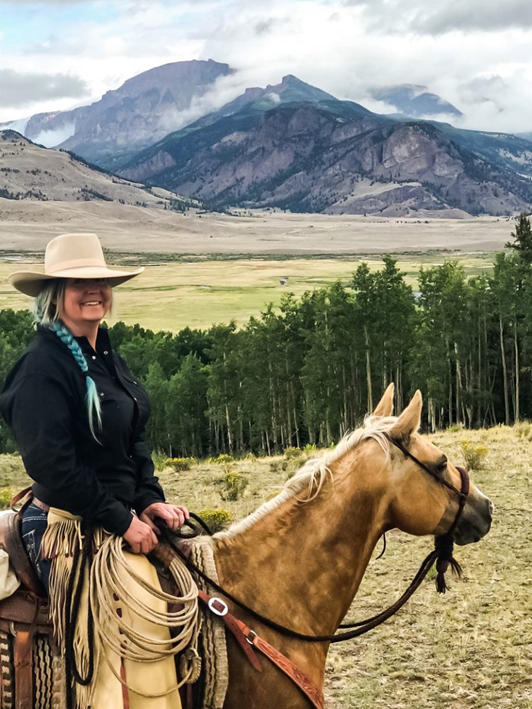 Nicole Grady sits on palomino horse