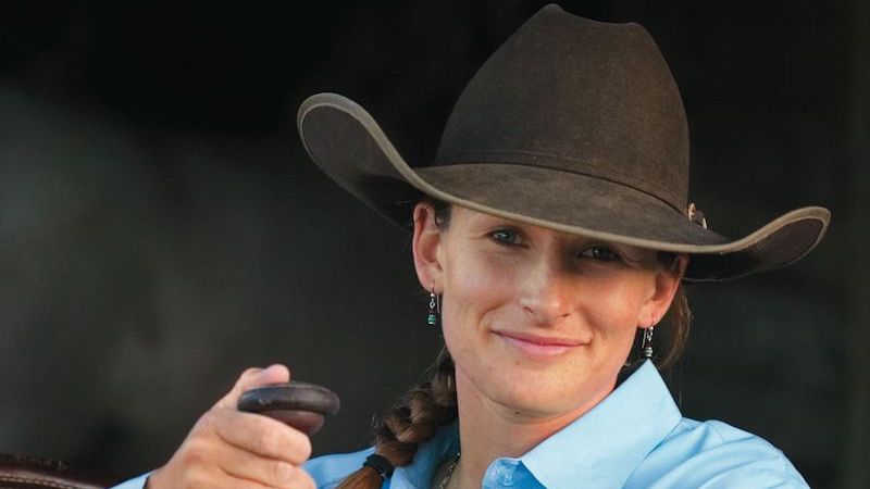 Kate Neubert leaning on saddle