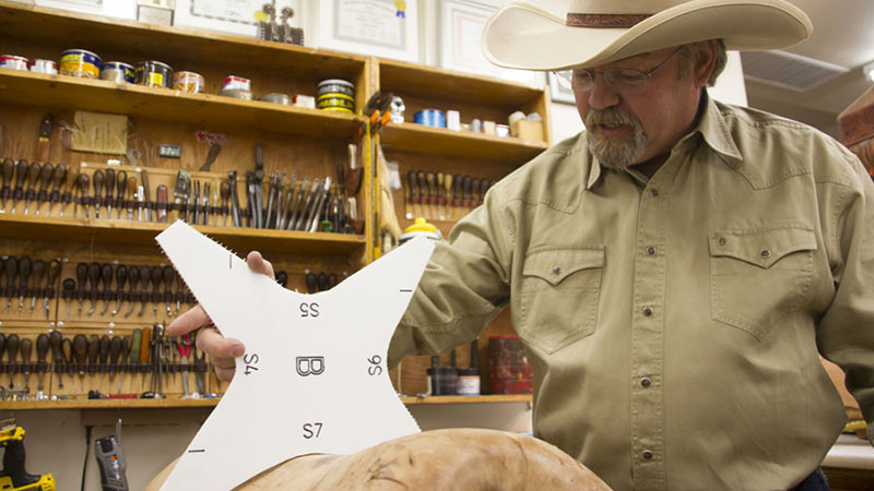 Keith Seidel testing the saddle fit of a saddle