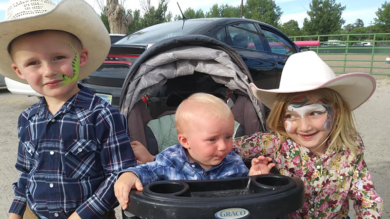 Kids with their face painted at the rodeo