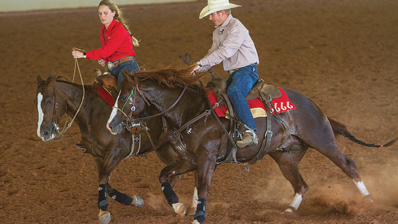 Terry and Sara Riddle ride horses at Four Sixes Ranch in Guthrie, Texas
