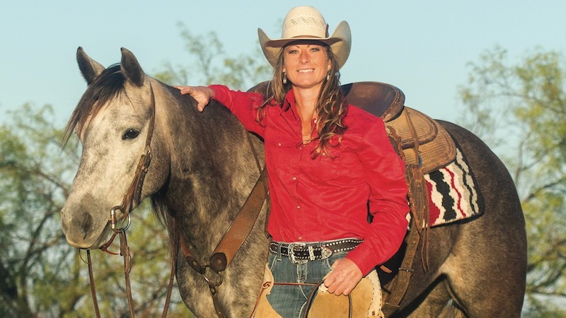 Tiffany McLaury standing with horse