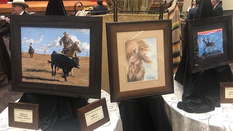 Winning art pieces of the 2019 Western Horseman youth art contest on display at the CA sale.