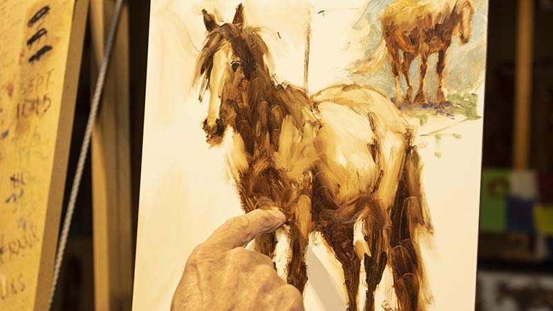 Jim Rey demonstrates how to paint a horse.