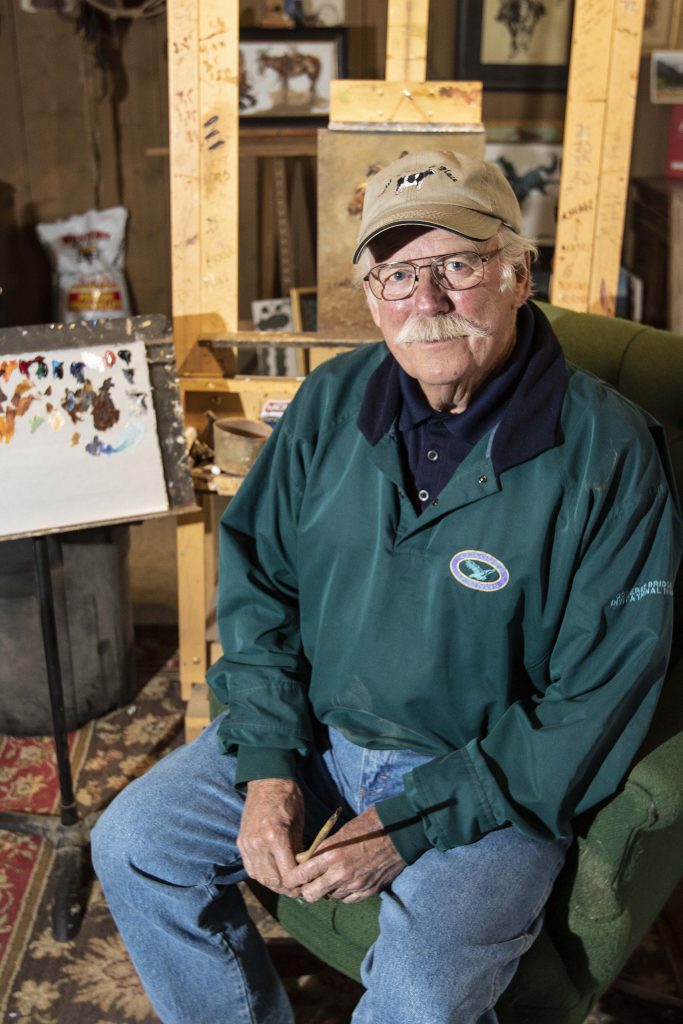 Jim Rey sits in his art studio.