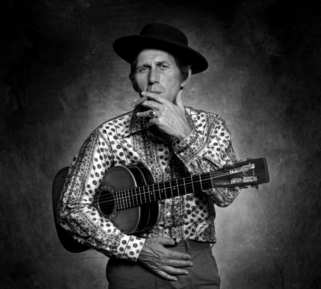 Chet Atkins stands for a portrait in Jim McGuire's studio.