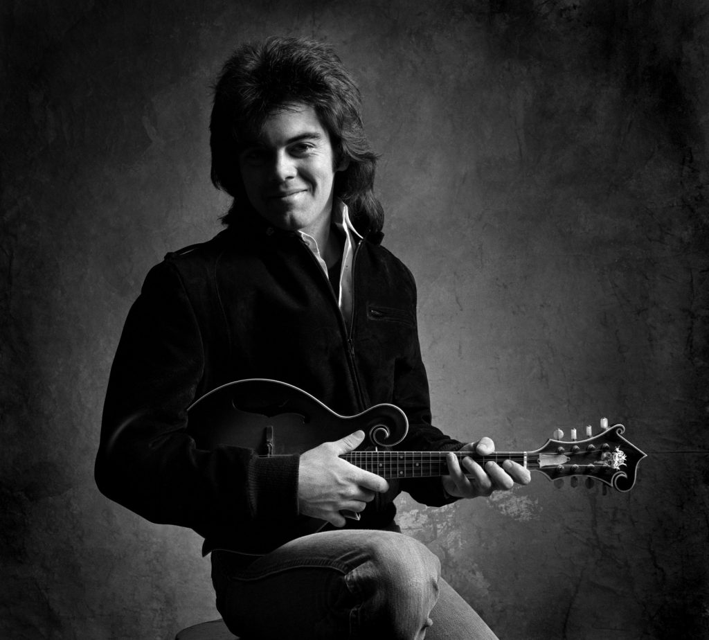 Marty Stuart holds a guitar for a photo taken by Jim McGuire