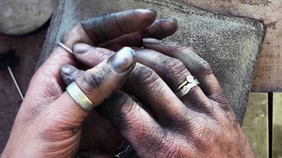 The hands of a craftsman reflect hours and years of hardwork making cowboy crafts.
