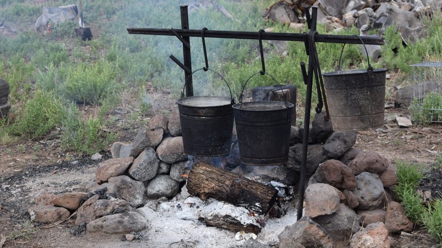 Jolyn Young prepares to cook at camp while her husbands catches wild cows.