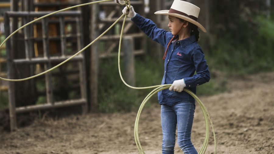 A student at rodeo school Rancho Apalache swings a rope.