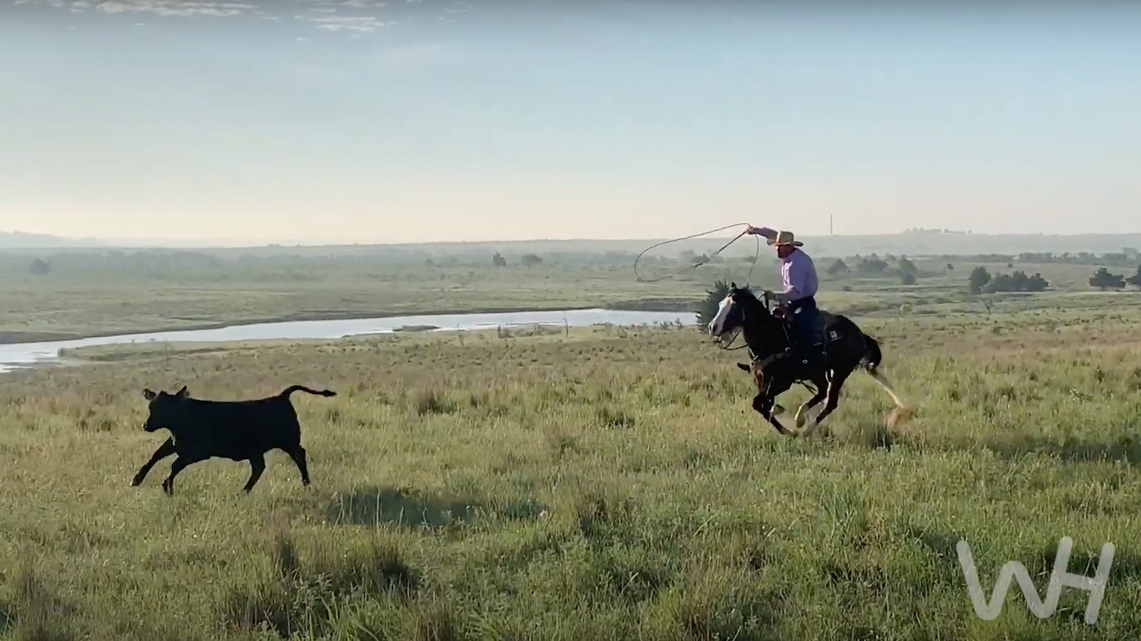 Miles Baker riding a young horse outside the arena