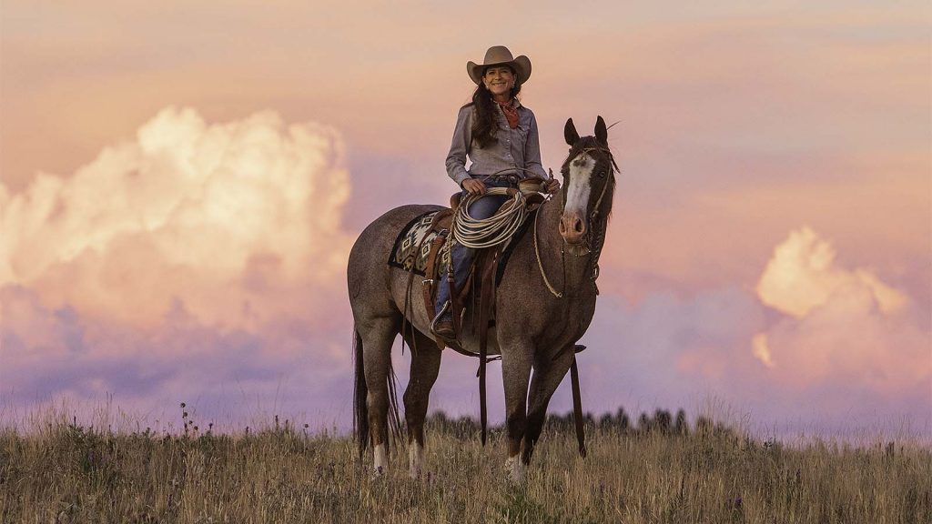 Cowgirl Tammy Pate rides her horse on the ranch.