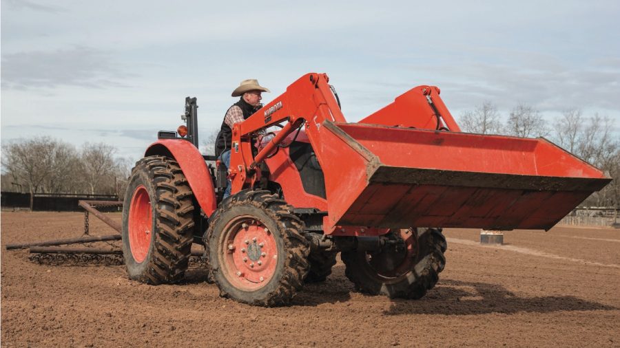 man on tractor with ranch equipment