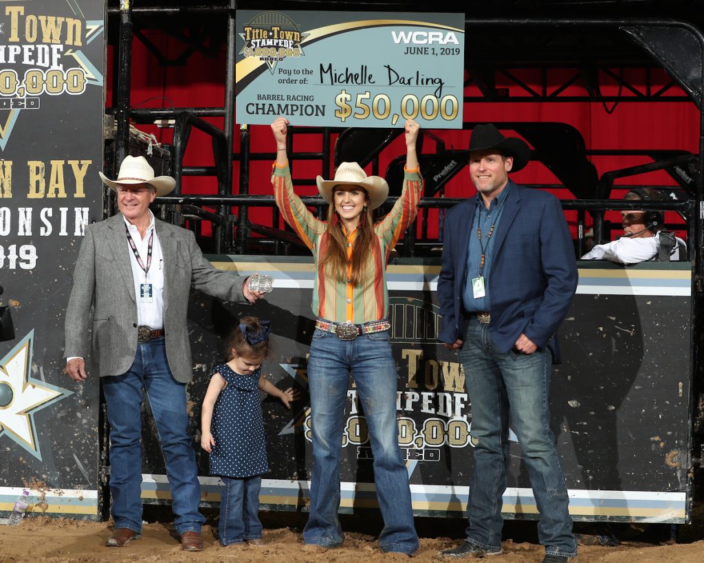 Michelle Darling holding up a check from the Green Bay WCRA