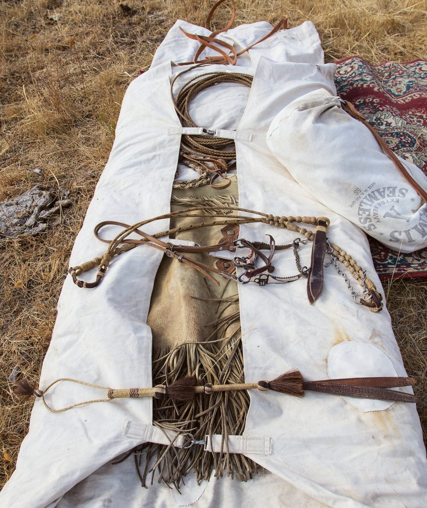 A bedroll with gear laid inside of it.