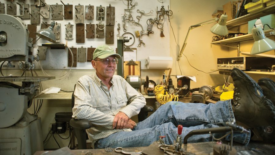 Tom Balding sits in his workshop