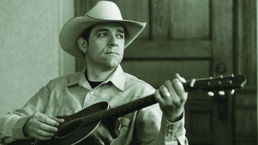 Andy Hedges holding a guitar
