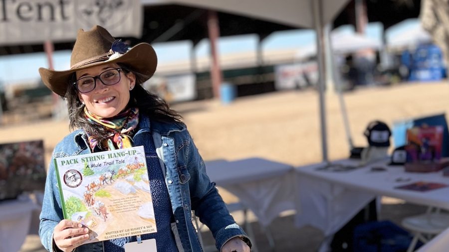 Liz Hughey holding her book