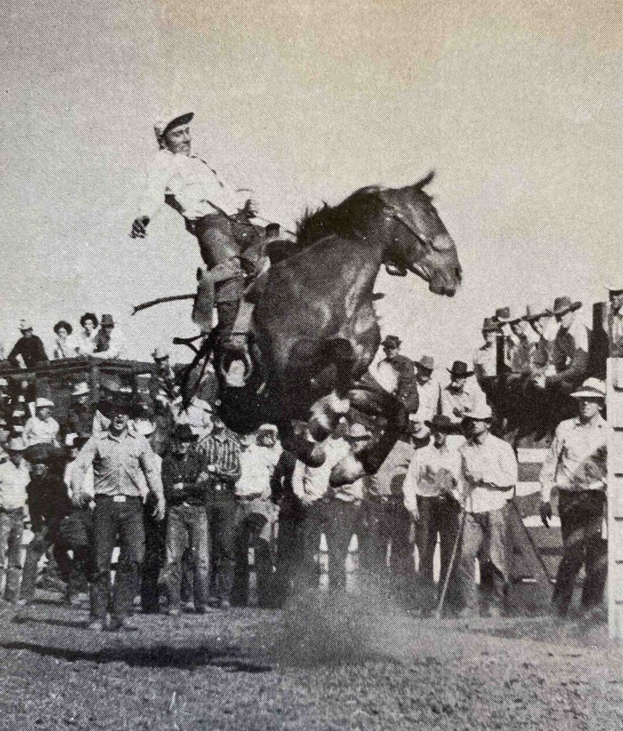 Dick Fairchild riding a bucking horse.