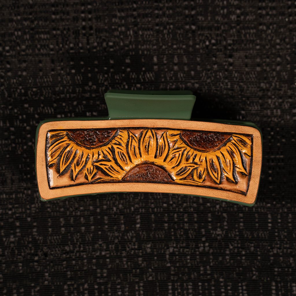 Tooled hair clip on black background.