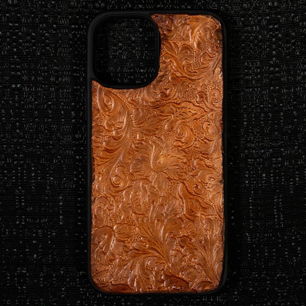 Tooled phone case on black background.