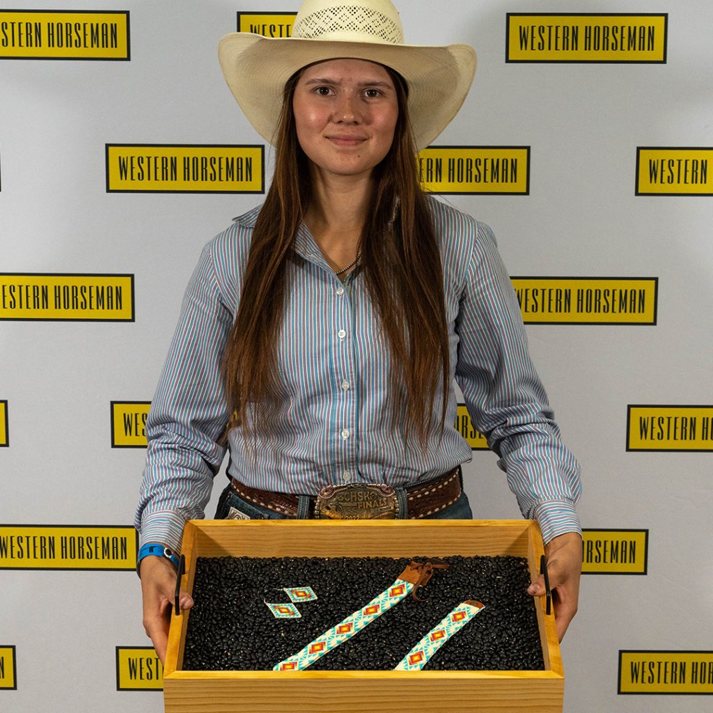 Ayla Goss holding her beaded set.
