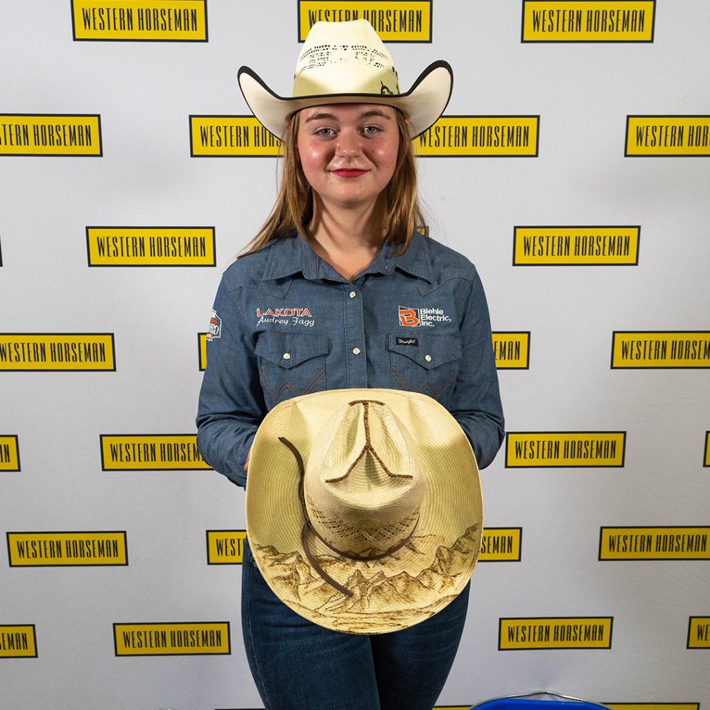 Audrey Fagg holding her hat with a Yellowstone crown.