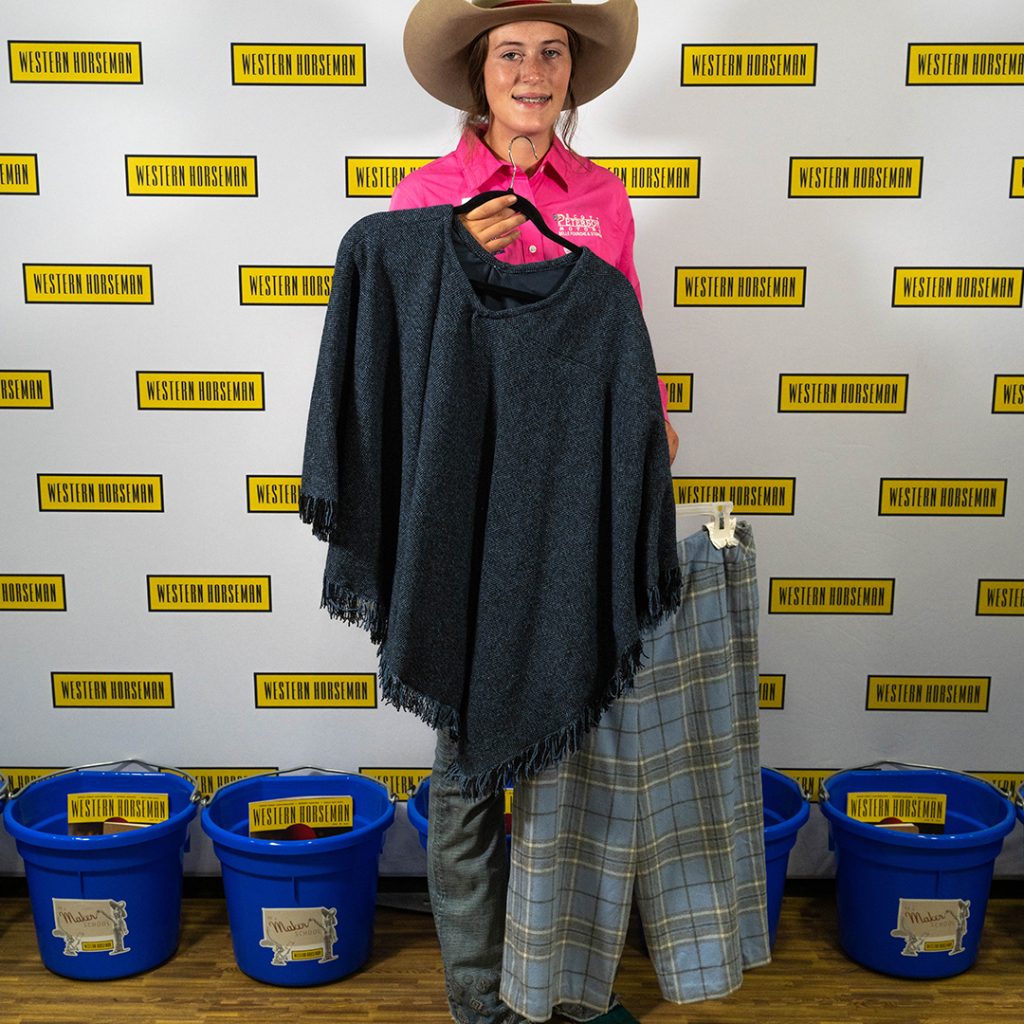 Tava Sexton holding her handmade wool outfit for the 2023 Western Lifestyle Trade Craft Showcase.